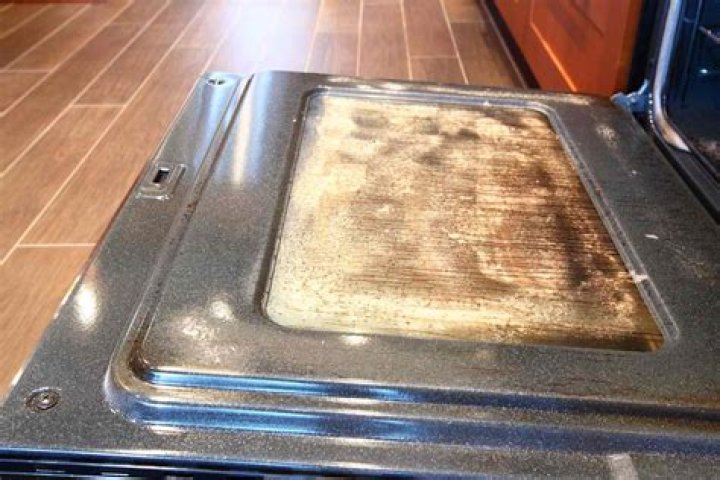 How do I get brown stains off my glass oven door?