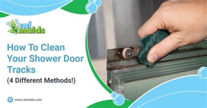 How do I keep my shower door tracks clean?
