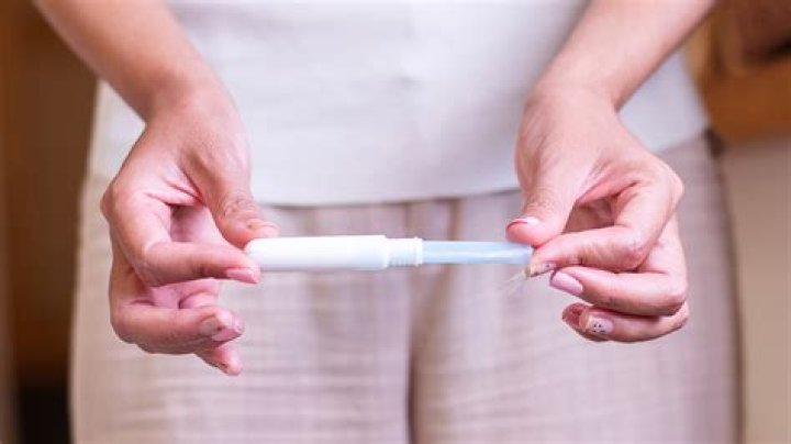 How do you put a tampon in at school?