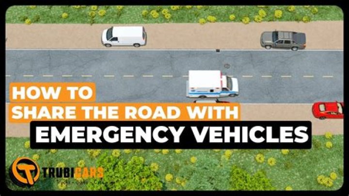 When an emergency vehicle is approaching and you are in the middle of an intersection you should?